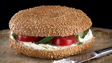 Poster - Rotating Bagels with Cream Cheese and vegetables as seamless loopable 4K UHD footage