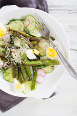 Wall Mural - Fresh salad of asparagus, cucumber and boiled eggs with parmesan