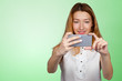 © fotofabrika - Close up portrait of a young fashionable woman holding a smartphone