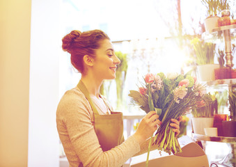 Poster - smiling florist woman making bunch at flower shop