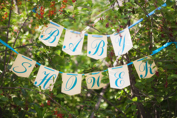 Baby shower scene, flags with letters on ribbon