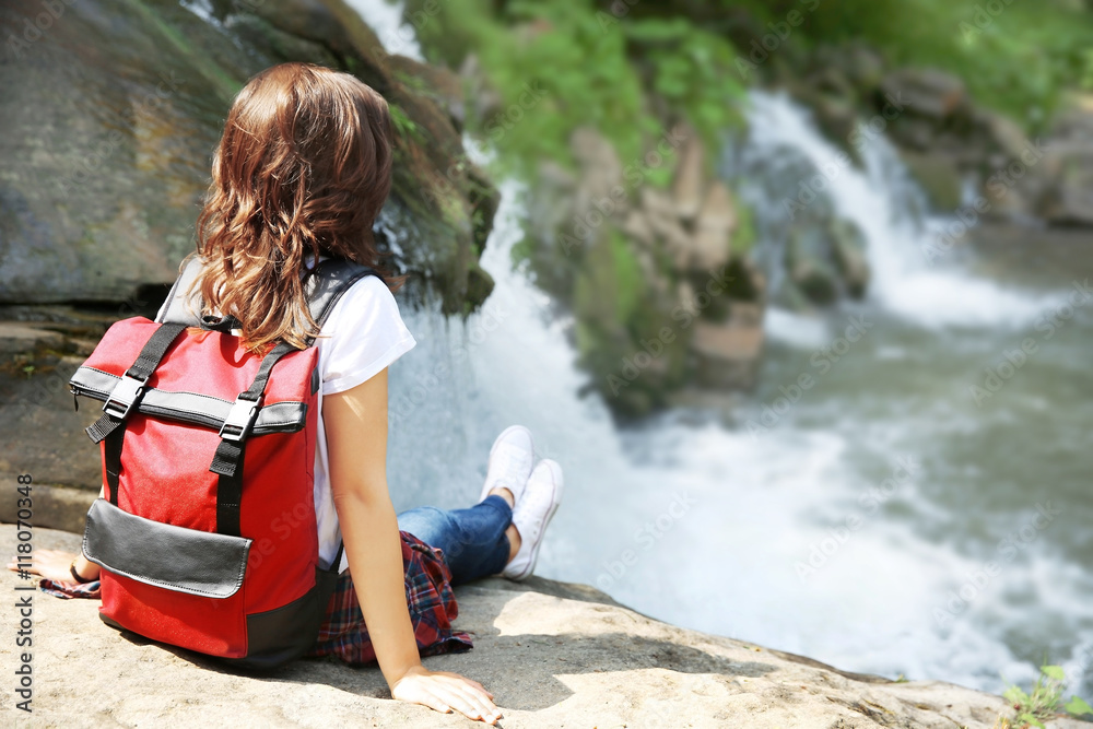 Female tourist beside the mountain river