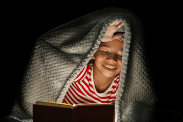 Wall Mural - Cute girl reading book at night