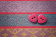Two hearts shaped buttons over a rustic pretty linen cloth