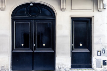 Two Georgian black gates at the entrance of a house