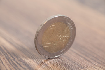 Two euro coin on a wooden surface, closeup