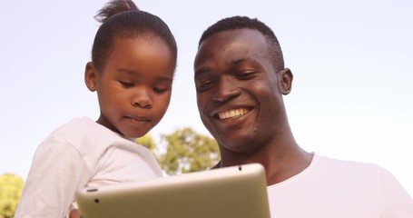 Poster - Man looking a tablet computer with his daughter