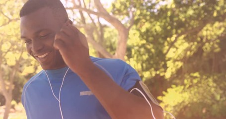 Poster - Sportsman is running with music in the park 