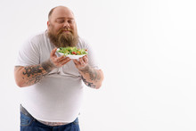Man Holding A Plate Of Salad