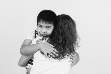 little boy sad in hugging of mother