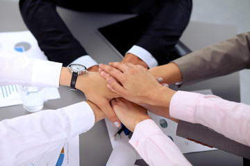 Business people group joining hands and representing concept of friendship and teamwork