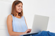 © ArtFamily - Young modern girl smiling softly in reply on a message