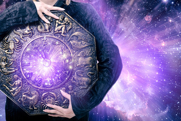 a woman holding zodiac with purple stars like an astrology concept
