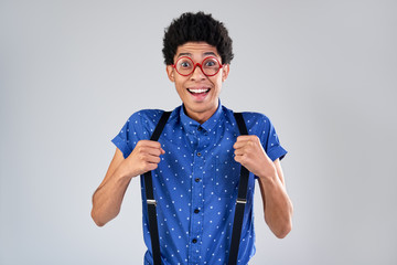 Funny guy portrait with suspenders and glasses surprised emotion