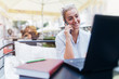 © hedgehog94 - Beautiful blong girl working on laptop and talking on mobile phone