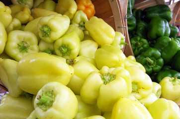 Wall Mural - Yellow peppers spill out from baskets on display