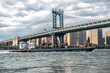 Commercial cargo vessel ship at Eat River in New York City under Manhattan Bridge