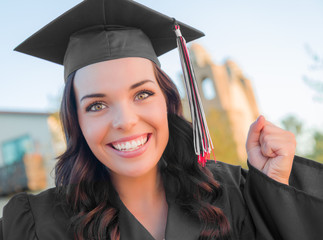 Happy Graduating Mixed Race Woman In Cap and Gown