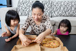 Leinwandbild Motiv Happy Asian Chinese Family Enjoying Pizza Together