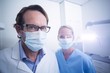 © WavebreakMediaMicro - Portrait of dental assistant and dentist wearing surgical mask