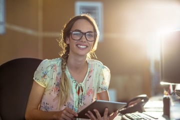 Poster - Smiling business executive using digital tablet in office
