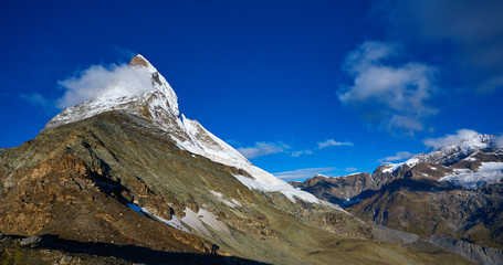 Wall Mural - Snow capped mountains. Matterhorn mount in the clouds at early morning. view of the north- eastern ridge . Trek near Matterhorn mount.