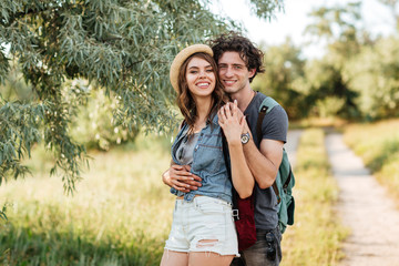 Poster - Young attractive hipster couple hugging at the forest