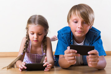 Wall Mural - Children burying in mobile phones .