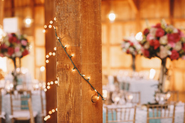 Wall Mural - Wooden columns decorated with light garlands