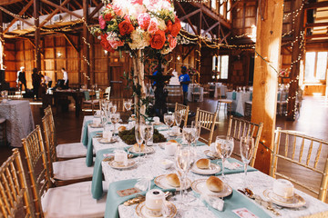 Wall Mural - Long dinner table covered with blue serviettes stands in the hal