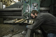 © Inti St Clair/Blend Images - Caucasian man working at machinery in metal shop