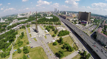 Megalopolis Panorama With Obelisk Conquerors Of Space, Hotel Cosmos, Ferris Wheel At Russian Exhibition Complex At Sunny Spring Day. Aerial View