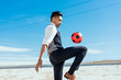 © Connect Images - Businessman playing with soccer ball on Los Angeles river, California, USA