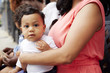 © Granger Wootz/Blend Images - Mother holding toddler son on lap outdoors