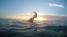 Woman Makes Spiral Splashing Water With Her Hair At Sea 