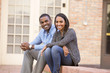 © Mike Kemp/Blend Images - Smiling couple sitting on steps