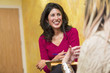 © Marc Romanelli/Blend Images - Hispanic women talking indoors
