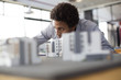 © Resolution Productions/Blend Images - Mixed race architect examining architectural model in office