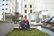 © Jasper Cole/Blend Images - Couple smiling in urban rooftop garden