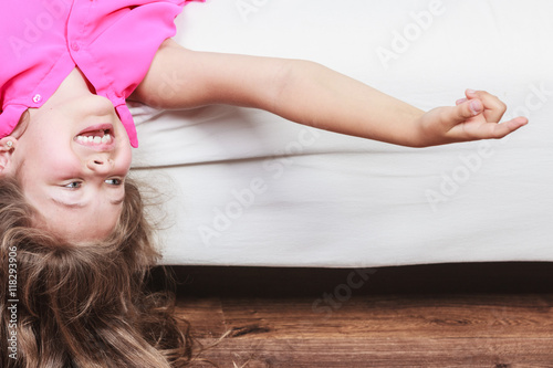 Little Girl Kid With Long Hair Upside Down On Sofa Buy This