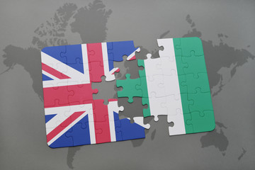 Wall Mural - puzzle with the national flag of great britain and nigeria on a world map background.