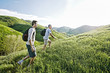 © Peathegee Inc/Blend Images - Caucasian father and son walking on grassy hillside