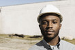 © Roberto Westbrook/Blend Images - Close up portrait of Black man wearing hard-hat at construction site