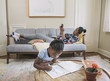 © Hello Lovely/Blend Images - African American mother and daughter relaxing in living room