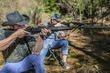 © Eric Raptosh Photography/Blend Images - Caucasian hunters aiming guns in forest