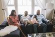 © Hello Lovely/Blend Images - African American family relaxing on sofa