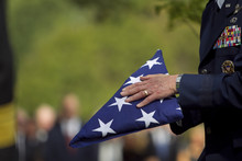 Soldier Folding Flag At Military Funeral