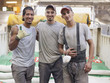 © Granger Wootz/Blend Images - Hispanic workers hugging in factory