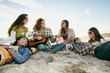 © Peathegee Inc/Blend Images - Friends relaxing together on beach