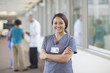 © John Fedele/Blend Images - Nurse smiling in hallway